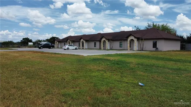 a large house with a big yard and large trees
