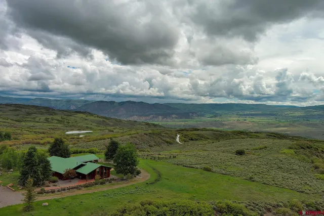 a view of a golf course with an ocean
