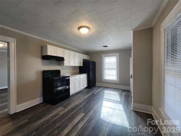 a kitchen with granite countertop a refrigerator and a stove