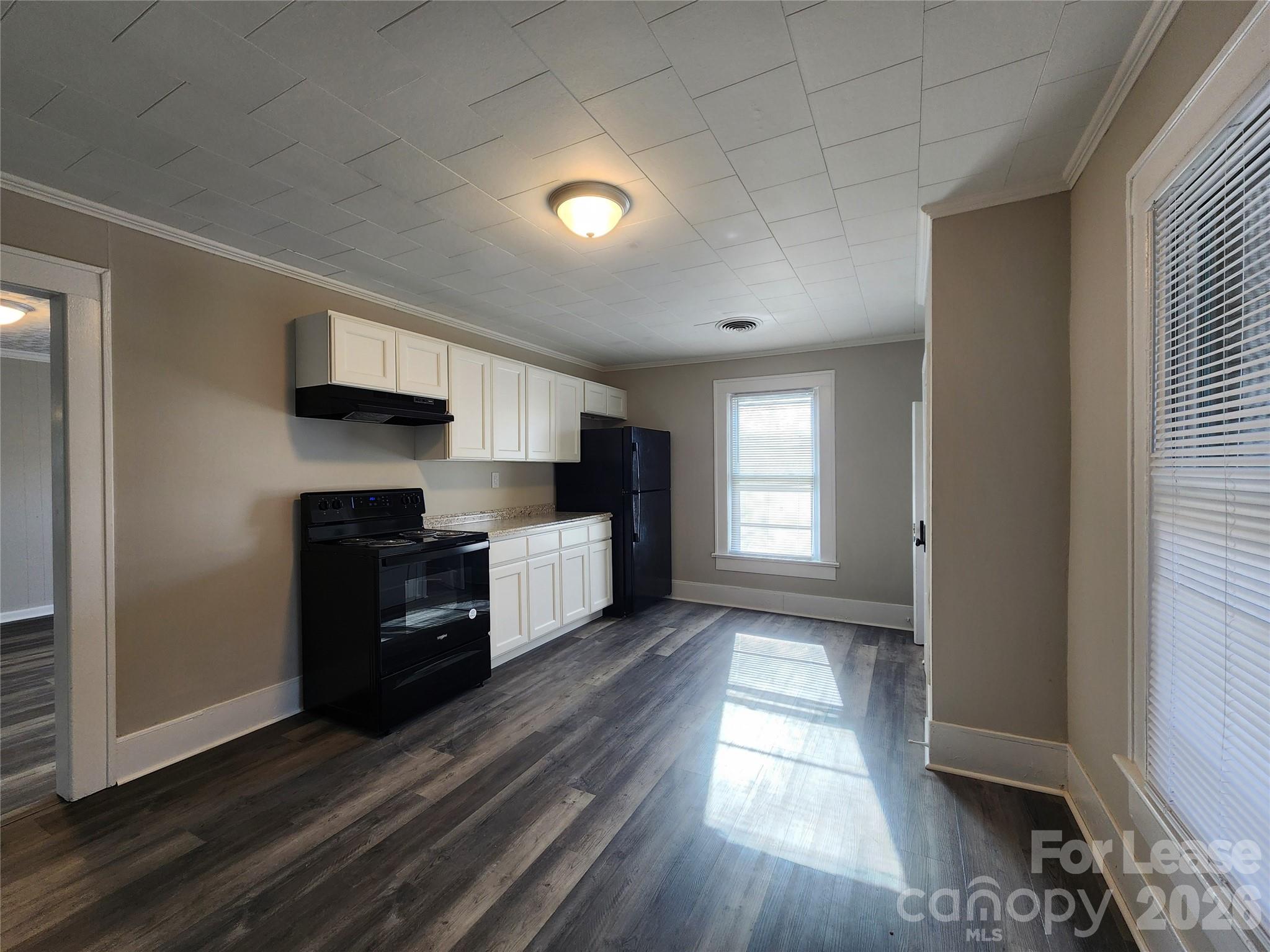 1126 South Fulton Street, Unit C Salisbury, NC 28144 - Photo 3 of 16 a kitchen with granite countertop a refrigerator and a stove