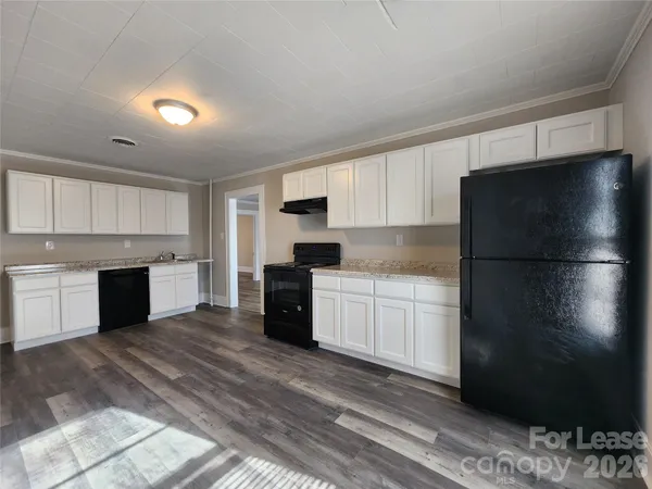a kitchen with a refrigerator and a stove top oven