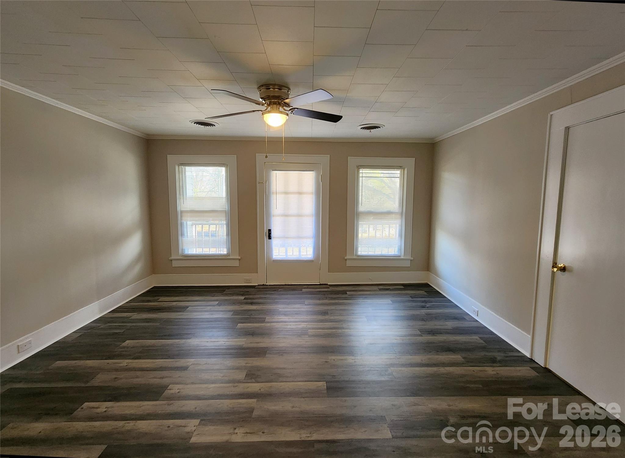 1126 South Fulton Street, Unit C Salisbury, NC 28144 - Photo 6 of 16 an empty room with wooden floor and windows