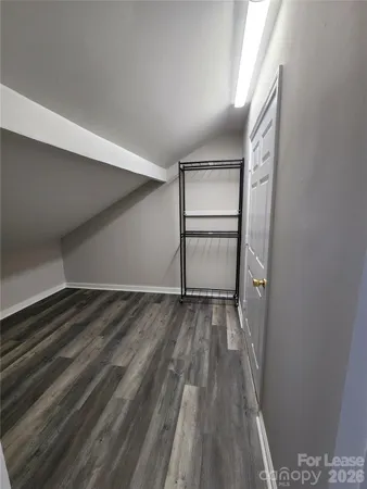 a view of a room with wooden floor