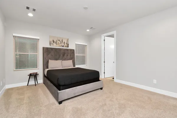 a room with a bed window and a table