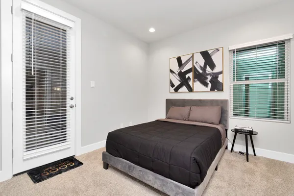 a bedroom with a bed and painting on the wall