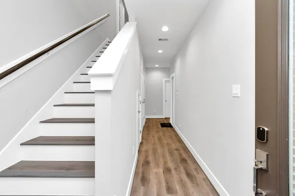 a view of entryway and hall with wooden floor