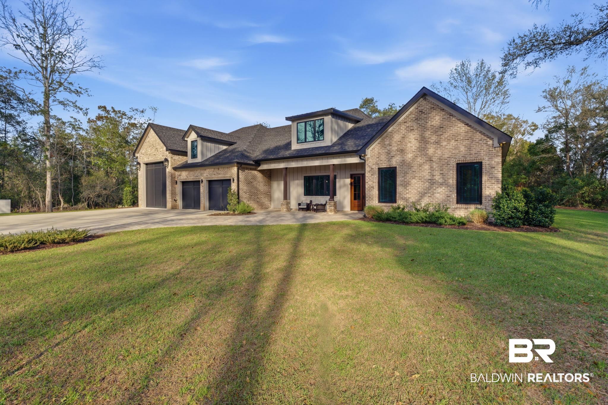 9501 Ben Hamilton Road Theodore, AL 36582 - Photo 7 of 69 View of front facade featuring brick siding, a front yard, a porch, and concrete driveway