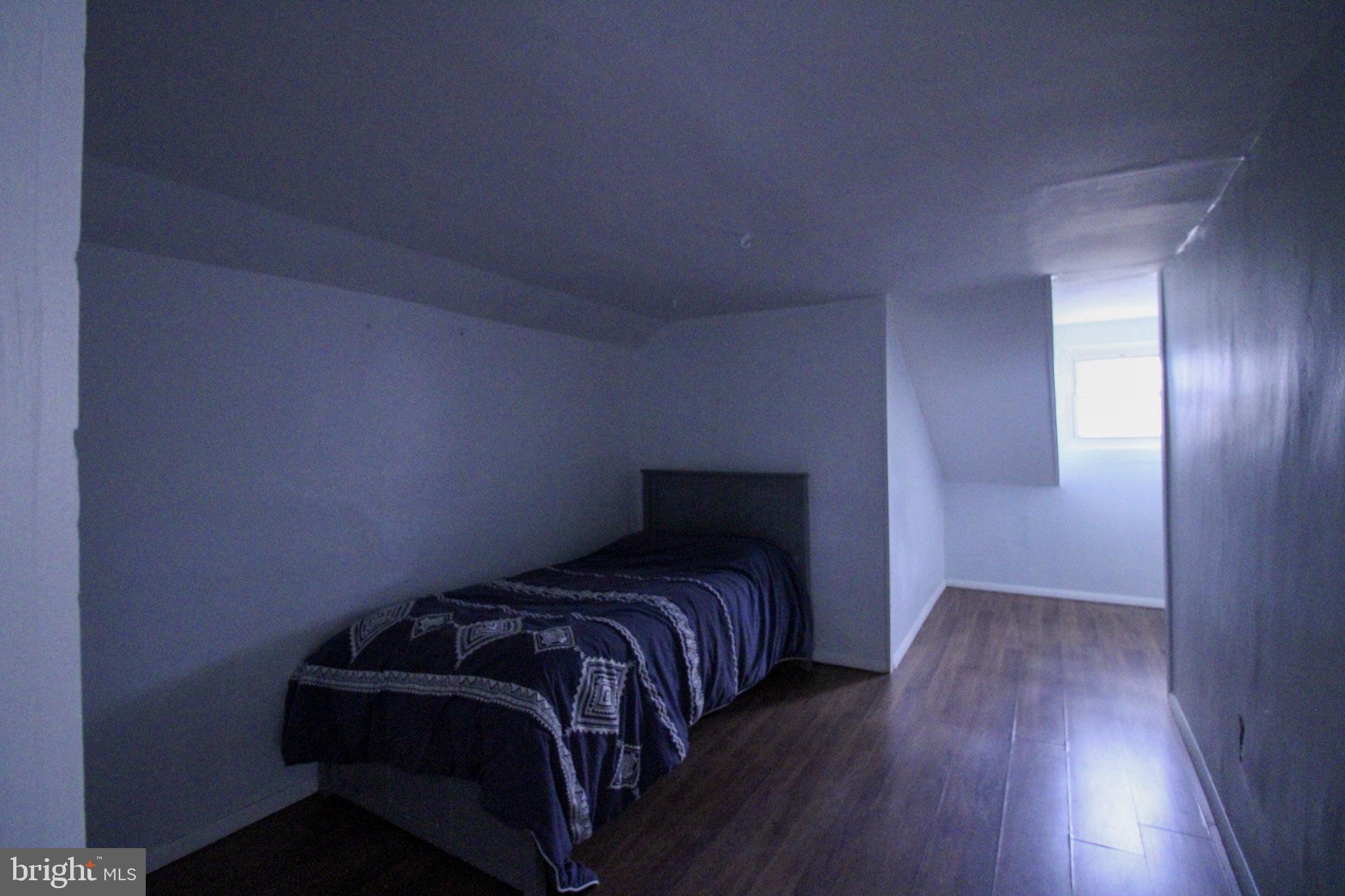 2486 Owl Town Road Callao, VA 22435 - Photo 13 of 14 a bed sitting in a bedroom next to a wooden door