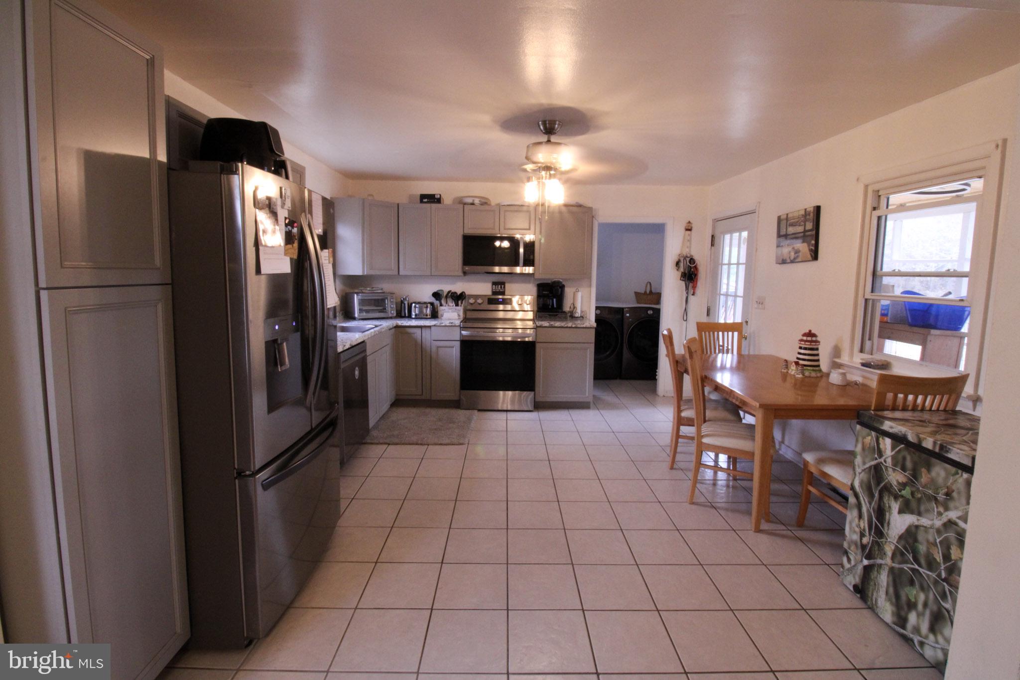2486 Owl Town Road Callao, VA 22435 - Photo 2 of 14 a kitchen with stainless steel appliances granite countertop a refrigerator and a stove