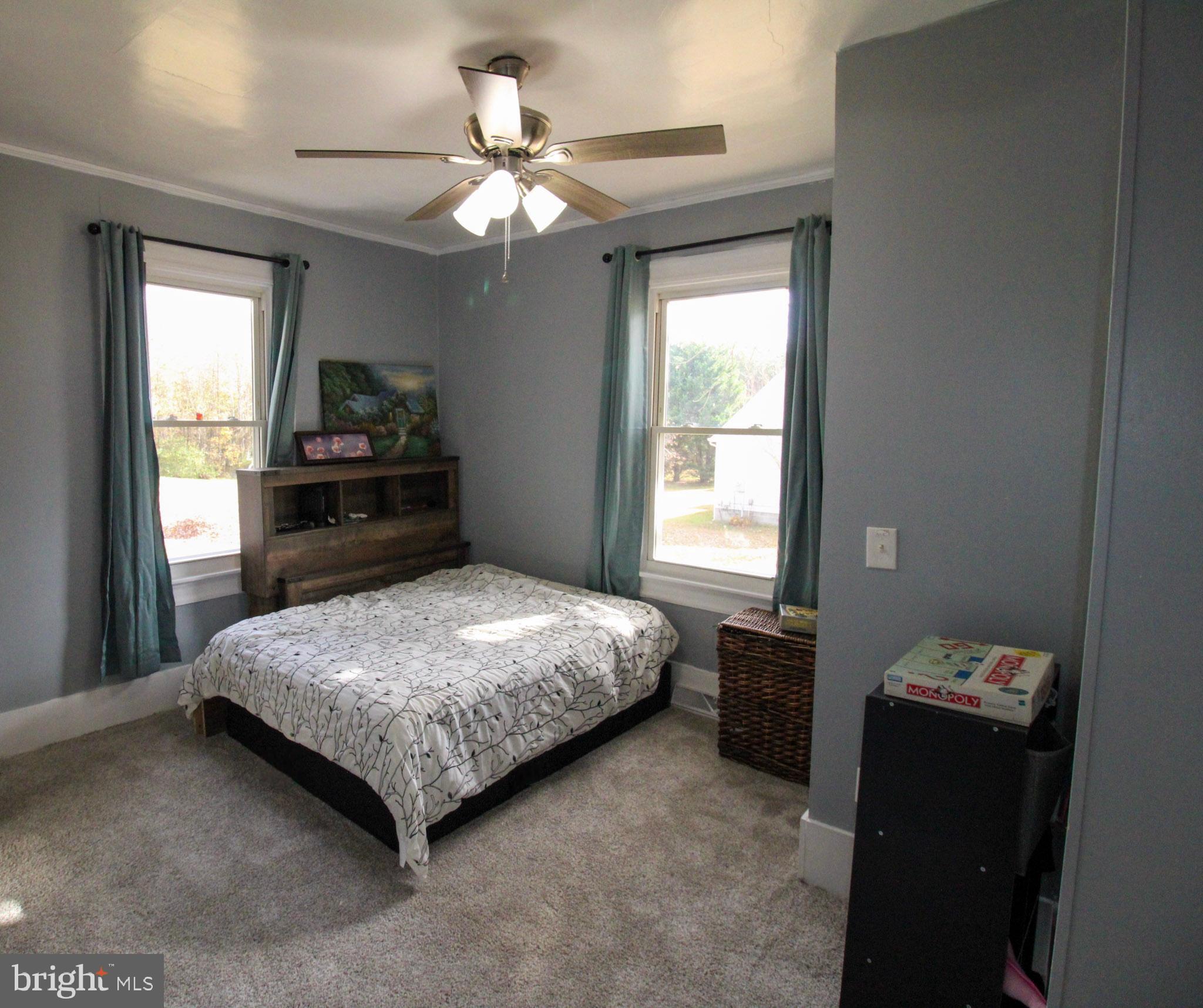 2486 Owl Town Road Callao, VA 22435 - Photo 6 of 14 a bedroom with a bed and a chandelier