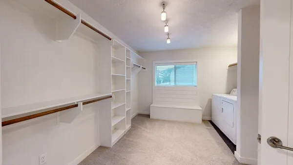 a view of storage and utility room with washer and dryer