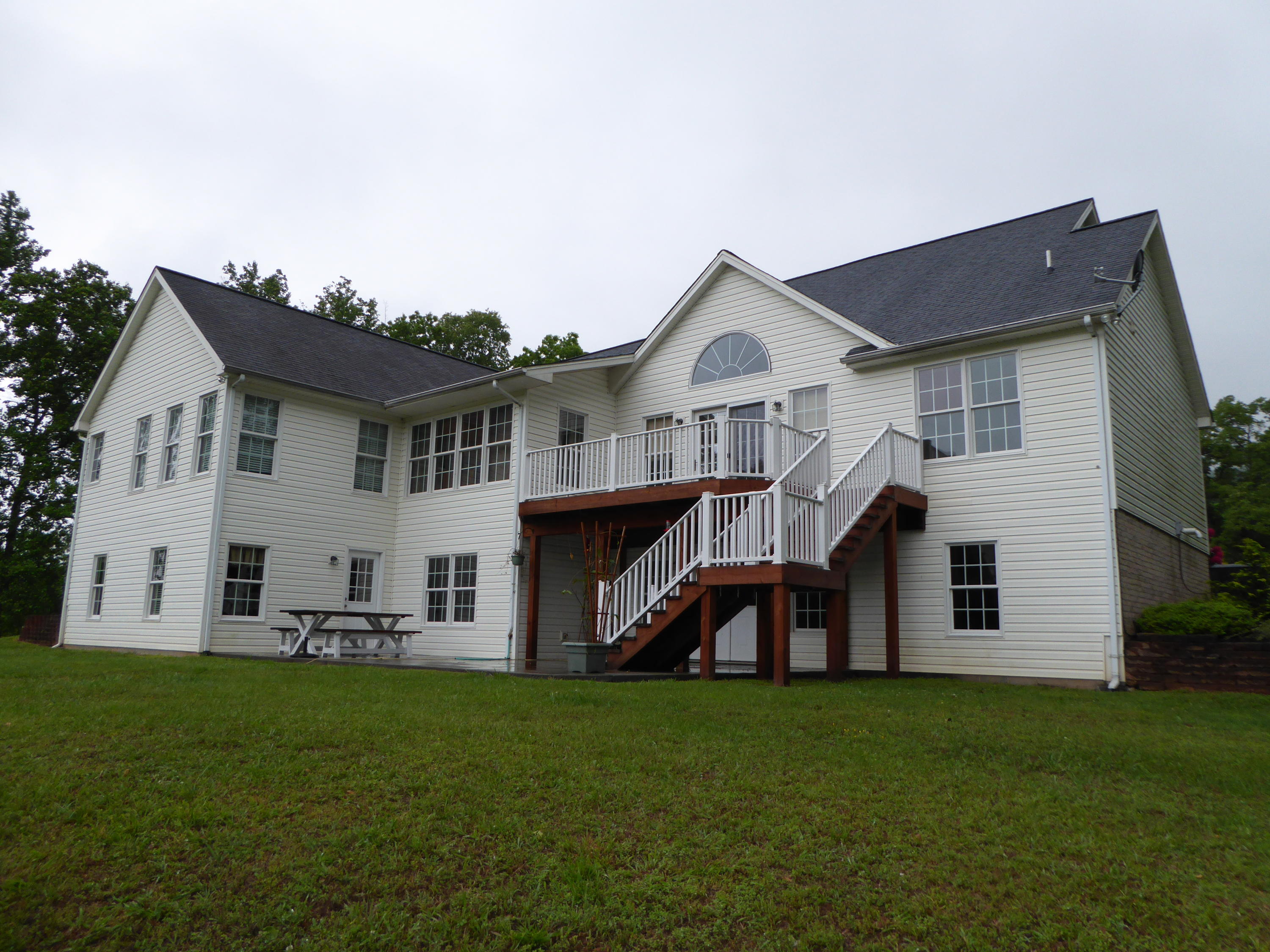 7740 Edwardsville Road Hardy, VA 24101 - Photo 2 of 92 a view of a house with a big yard and large trees