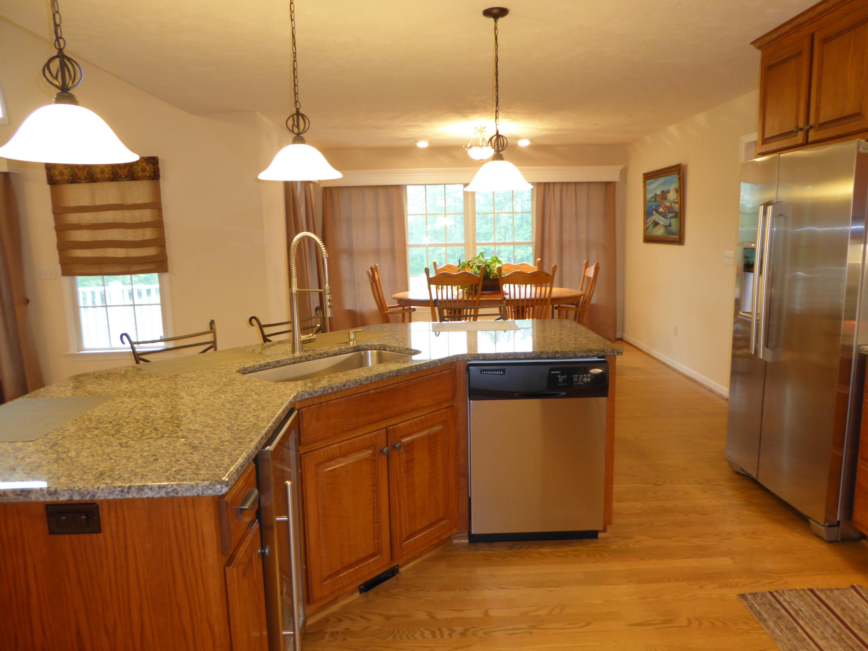 7740 Edwardsville Road Hardy, VA 24101 - Photo 11 of 92 a kitchen with stainless steel appliances granite countertop wooden cabinets a window a sink and a counter