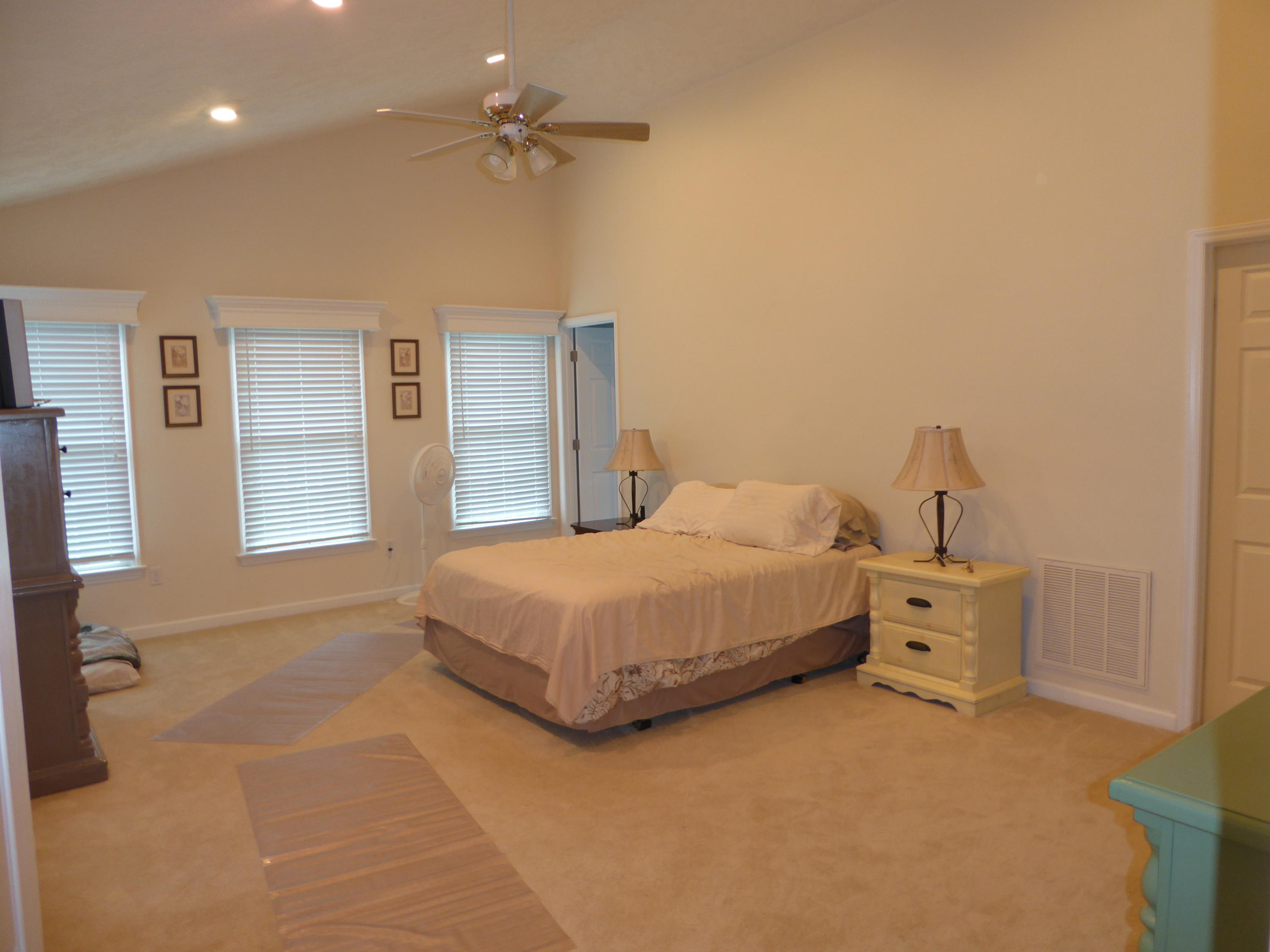 7740 Edwardsville Road Hardy, VA 24101 - Photo 15 of 92 a bedroom with a large bed and a chandelier