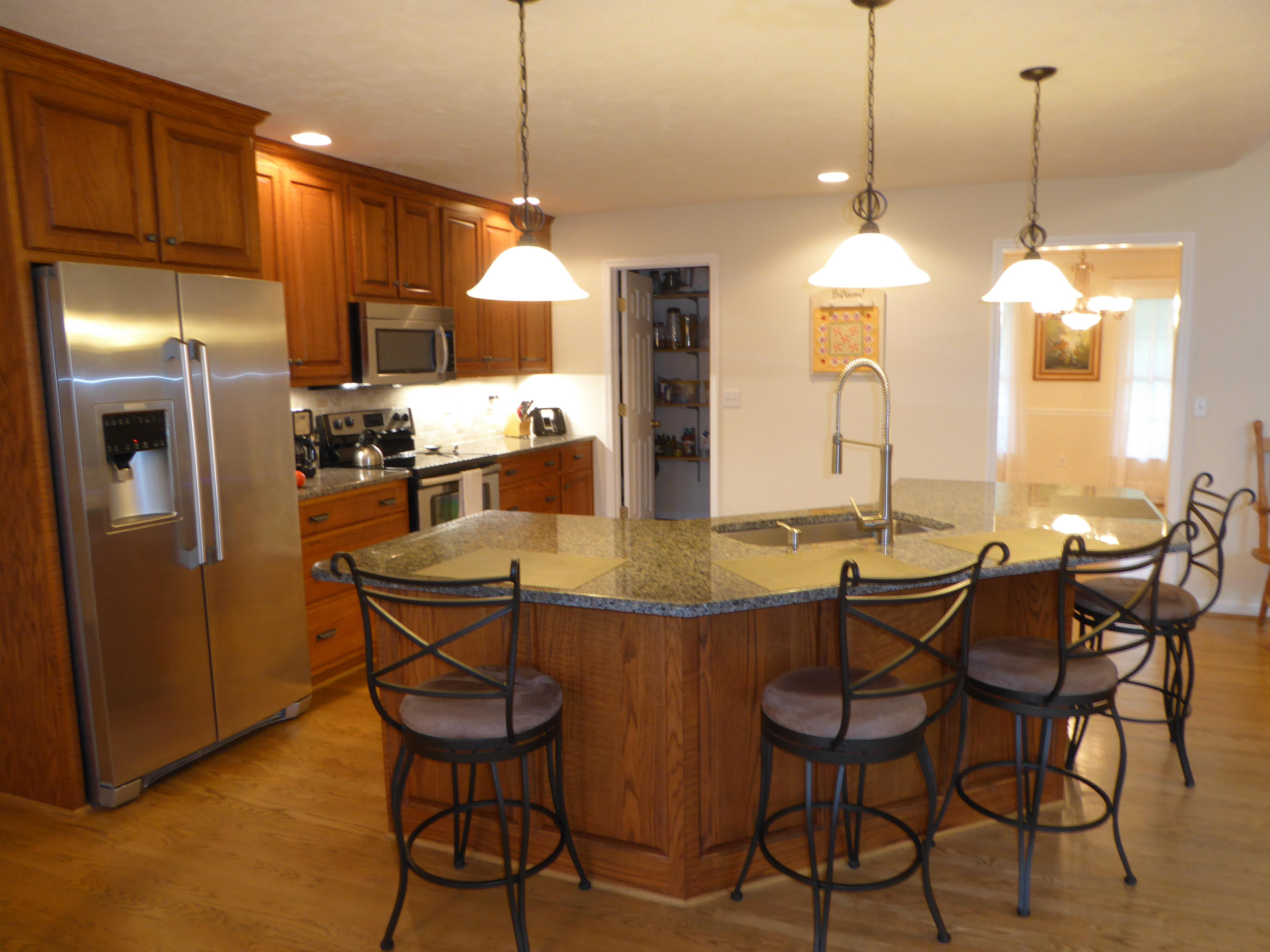 7740 Edwardsville Road Hardy, VA 24101 - Photo 10 of 92 a view of a dining room with furniture a chandelier and kitchen view