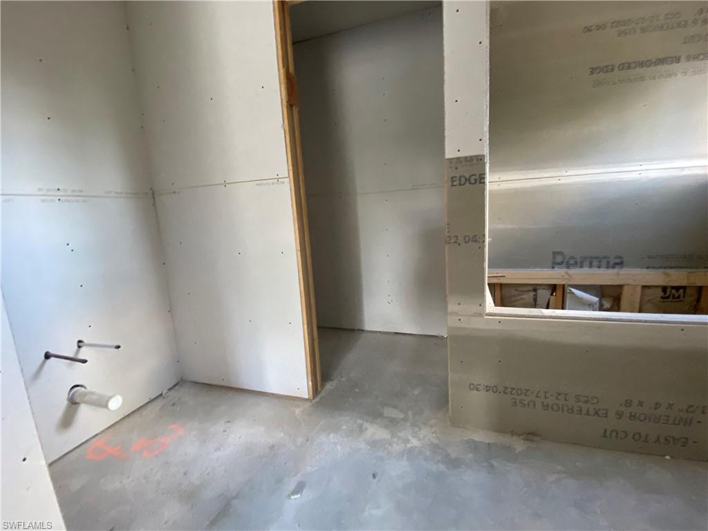 3317 7th Street Southwest Lehigh Acres, FL 33976 - Photo 12 of 23 an empty room with a door