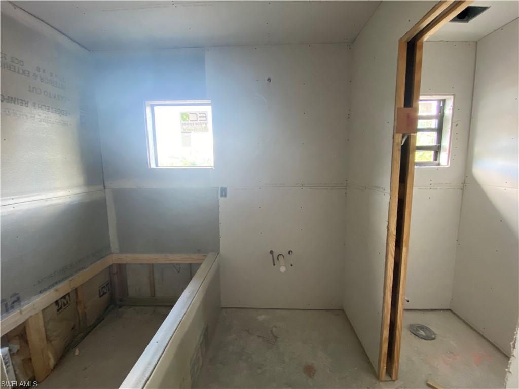 3317 7th Street Southwest Lehigh Acres, FL 33976 - Photo 13 of 23 a bathroom with a tub sink and window