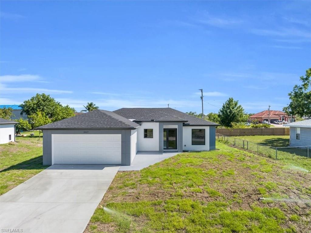 3317 7th Street Southwest Lehigh Acres, FL 33976 - Photo 14 of 23 a front view of a house with garden