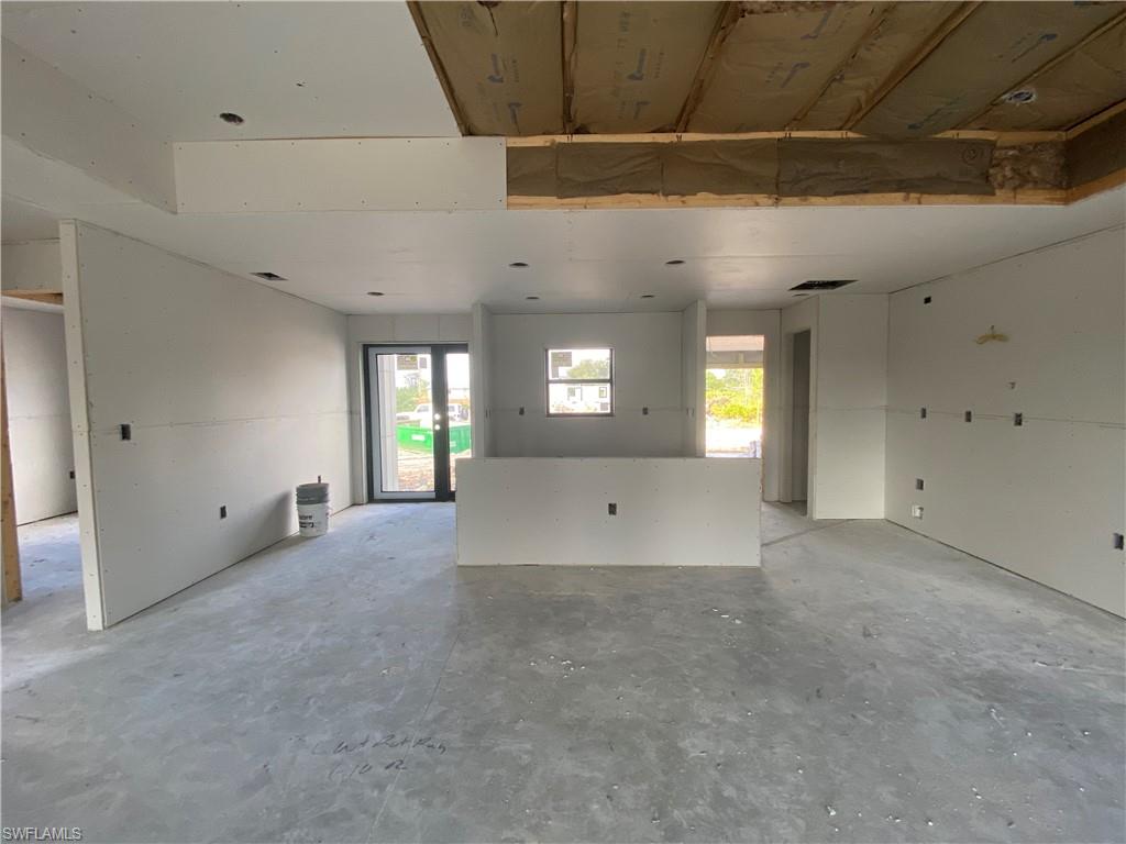 3317 7th Street Southwest Lehigh Acres, FL 33976 - Photo 2 of 23 a view of an empty room with window and wooden floor