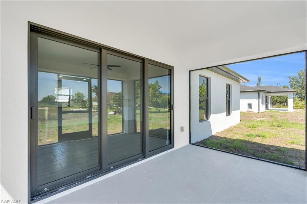3317 7th Street Southwest Lehigh Acres, FL 33976 - Photo 22 of 23 a view of porch with a floor to ceiling window and a room