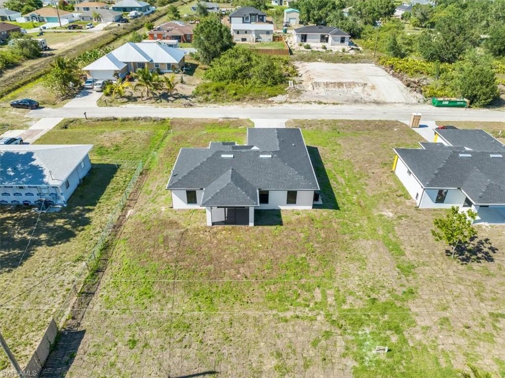 3317 7th Street Southwest Lehigh Acres, FL 33976 - Photo 23 of 23 an aerial view of residential houses with yard