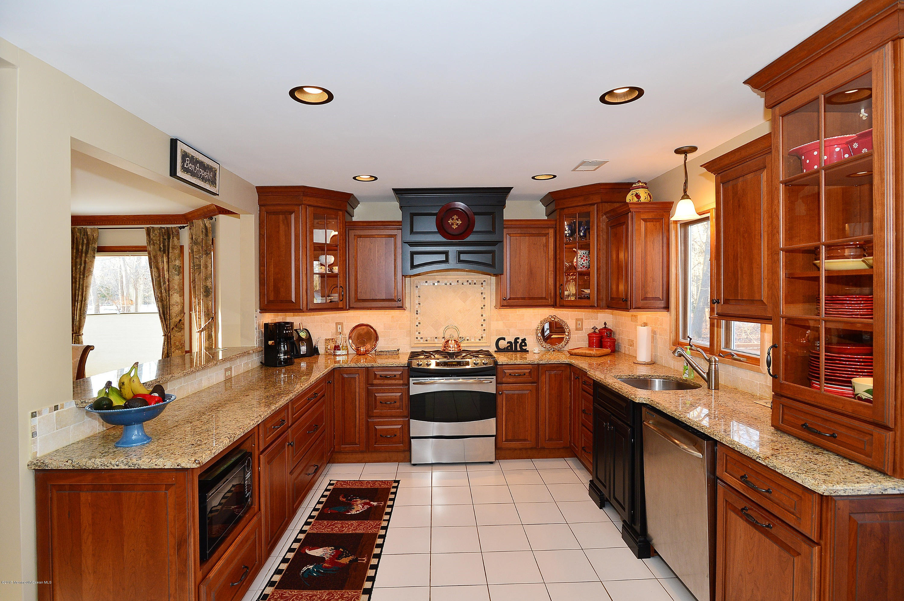 104 Drift Road Freehold, NJ 07728 - Photo 8 of 26 a kitchen with stainless steel appliances a sink stove and wooden cabinets