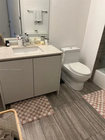 a bathroom with a sink a toilet and a mirror