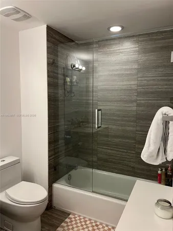 a bathroom with a shower and a toilet