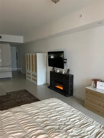 a bedroom with a bed and a television in it