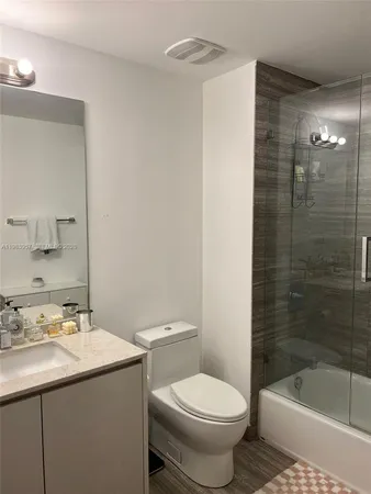 a bathroom with a sink toilet and shower