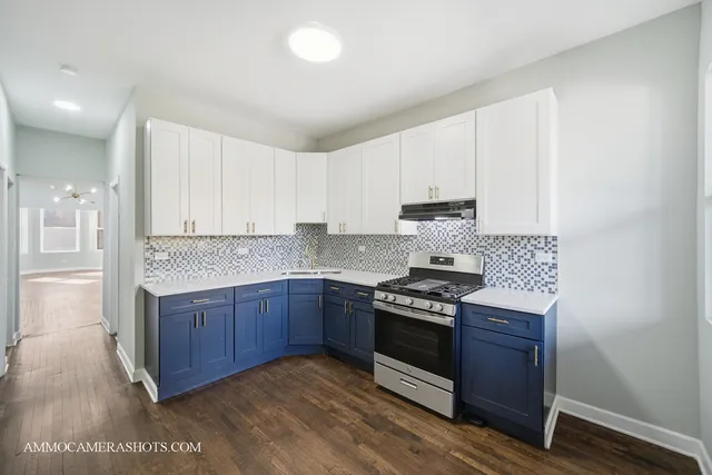 a kitchen with stainless steel appliances granite countertop wooden cabinets and a stove top oven