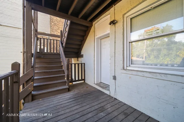 a view of entryway with wooden floor and stairs