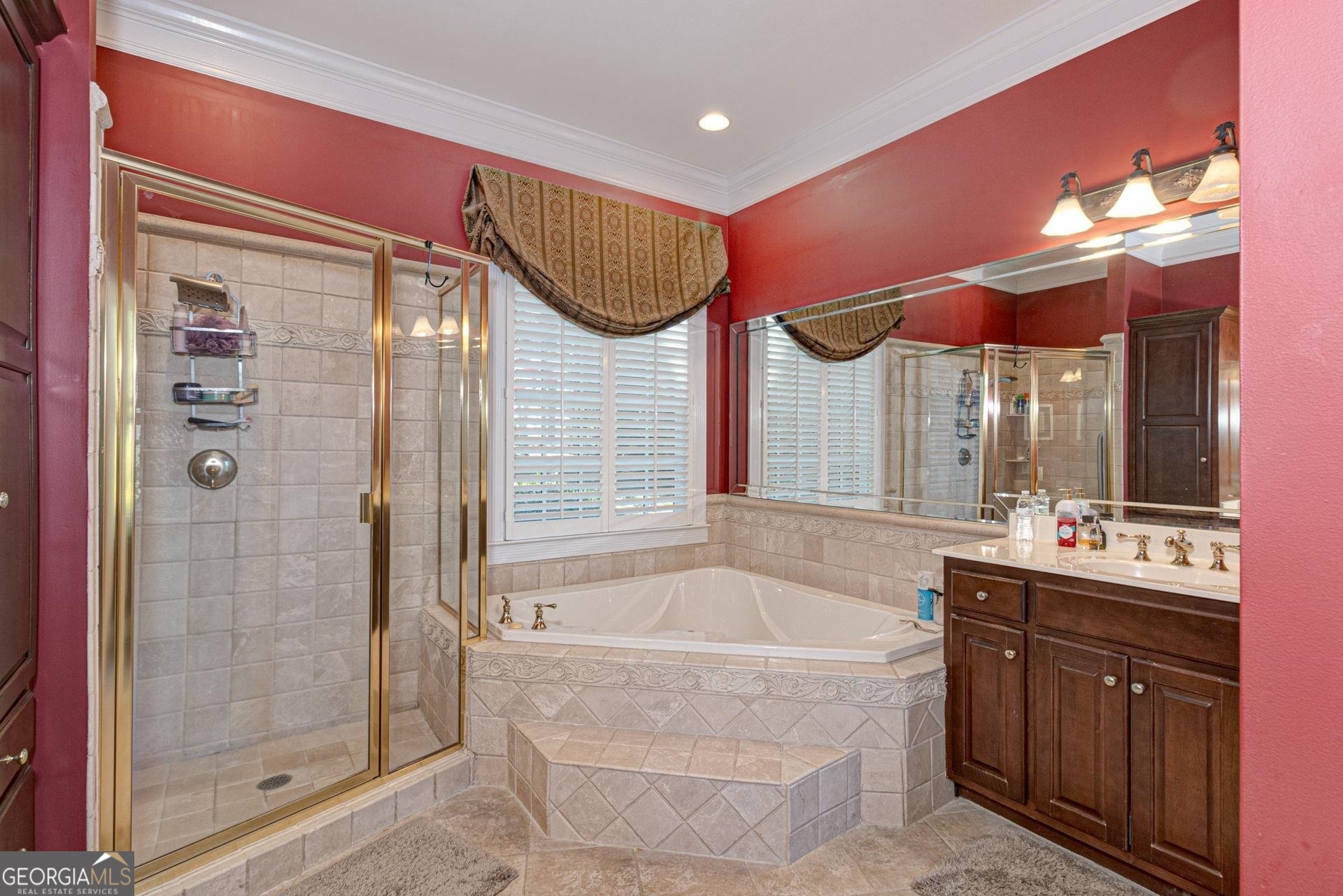 551 Mountain Ridge Drive Manchester, GA 31816 - Photo 27 of 72 Spa like tub corner tub and separate shower can be found in this en suite bathroom. Tiled floors and shower, and tile around the tub are a nice upgrade.