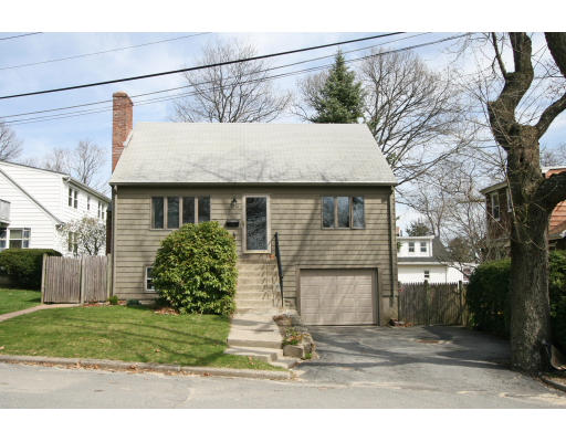 a view of a house with a yard and garage