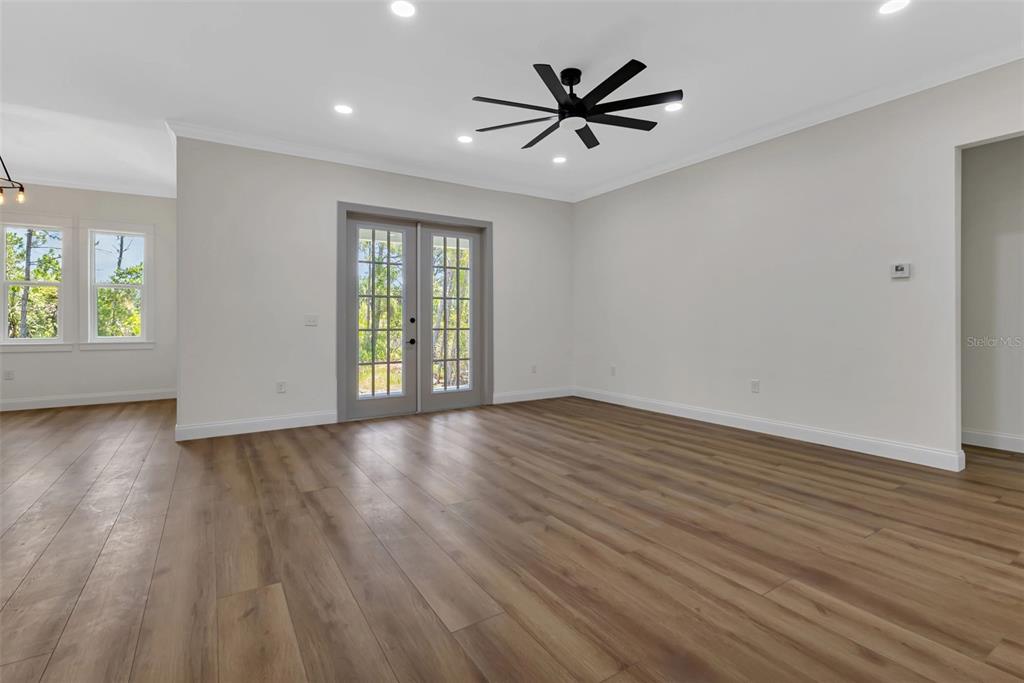 2444 Jacobs Street Port Charlotte, FL 33953 - Photo 20 of 52 an empty room with wooden floor and windows