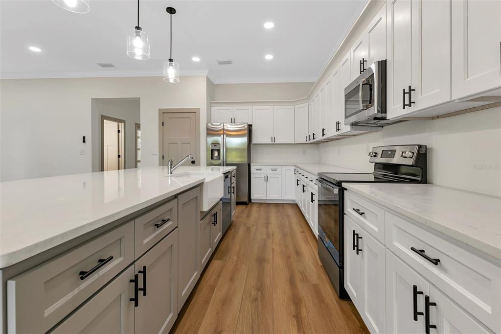 2444 Jacobs Street Port Charlotte, FL 33953 - Photo 2 of 52 a large kitchen with stainless steel appliances granite countertop a lot of counter space
