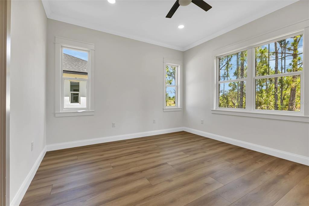 2444 Jacobs Street Port Charlotte, FL 33953 - Photo 25 of 52 a view of an empty room with window and wooden floor