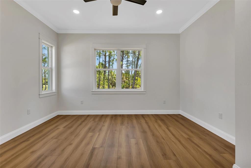 2444 Jacobs Street Port Charlotte, FL 33953 - Photo 26 of 52 wooden floor in an empty room with a window