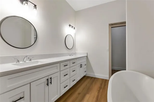 a bathroom with a double vanity sink and a mirror