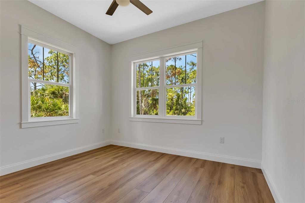 2444 Jacobs Street Port Charlotte, FL 33953 - Photo 33 of 52 a view of an empty room with wooden floor and a window
