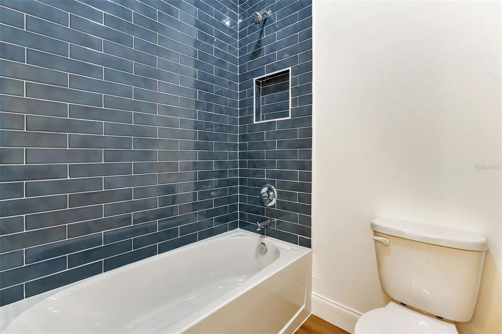 2444 Jacobs Street Port Charlotte, FL 33953 - Photo 37 of 52 a bathroom with a toilet bathtub and sink