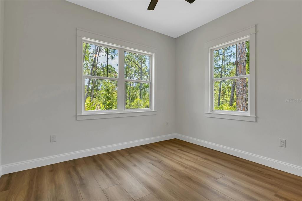 2444 Jacobs Street Port Charlotte, FL 33953 - Photo 41 of 52 a view of an empty room with wooden floor and a window