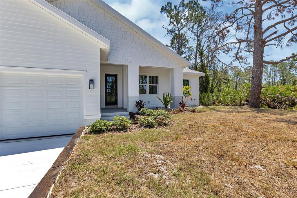 2444 Jacobs Street Port Charlotte, FL 33953 - Photo 47 of 52 a view of a house with a flower garden