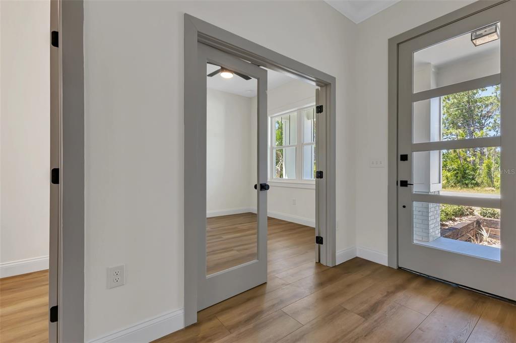 2444 Jacobs Street Port Charlotte, FL 33953 - Photo 7 of 52 an empty room with wooden floor and windows