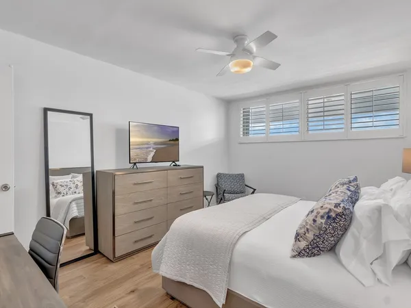 a bedroom with a bed and a television