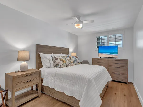 a bedroom with a bed and a night stand