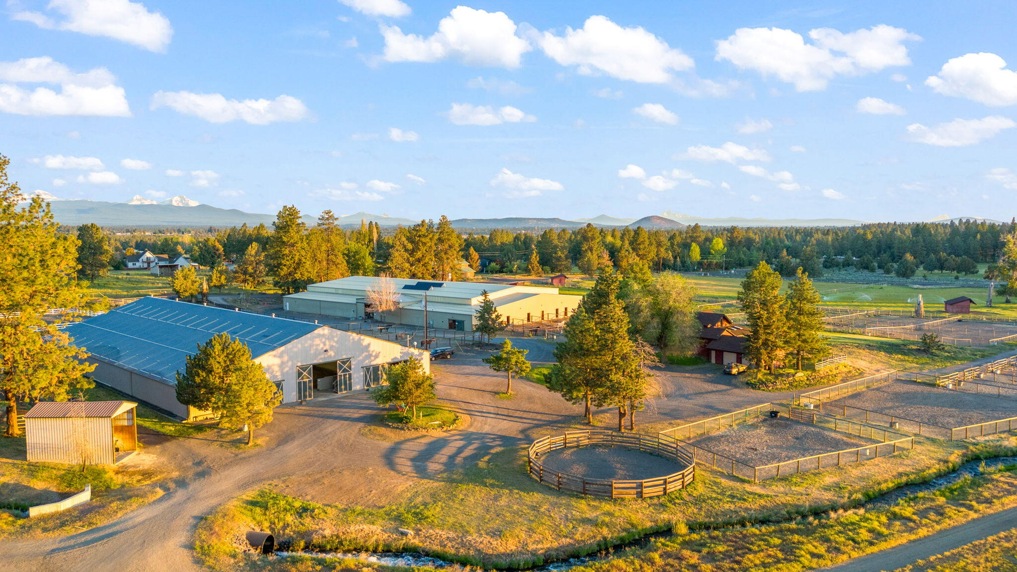 60360 Horse Butte Road Bend, OR 97702 - Photo 2 of 58 an aerial view of a house with swimming pool and lake view