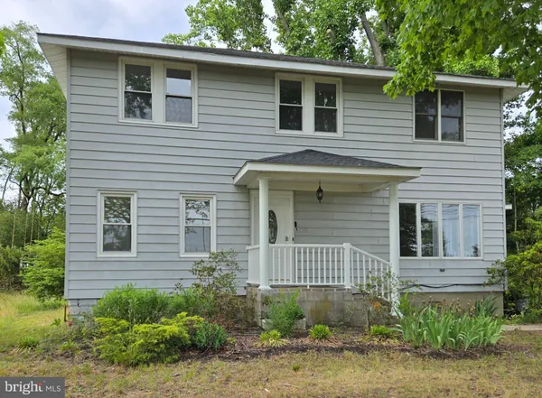 a view of a house with a yard and plants