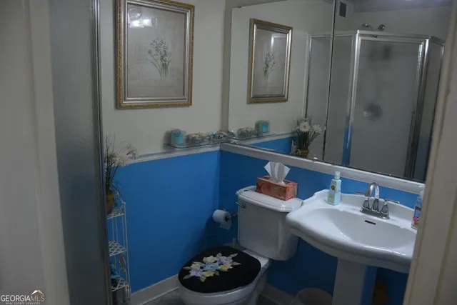 a bathroom with a sink a toilet and mirror