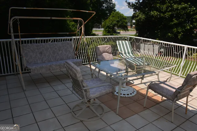 a view of a roof deck with wooden floor and fence